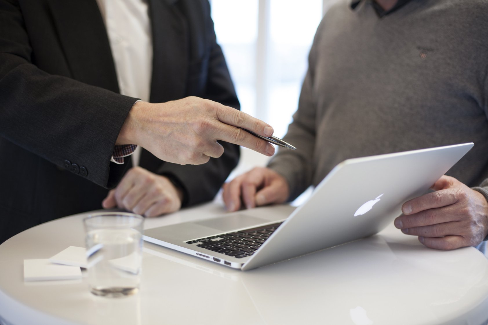 Businessmen In A Meeting At Desk With Laptop